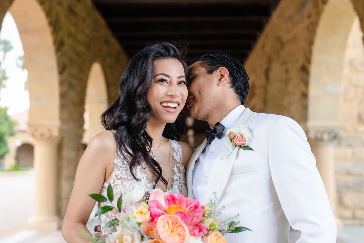 Couple holding a colorful wedding bouquet together