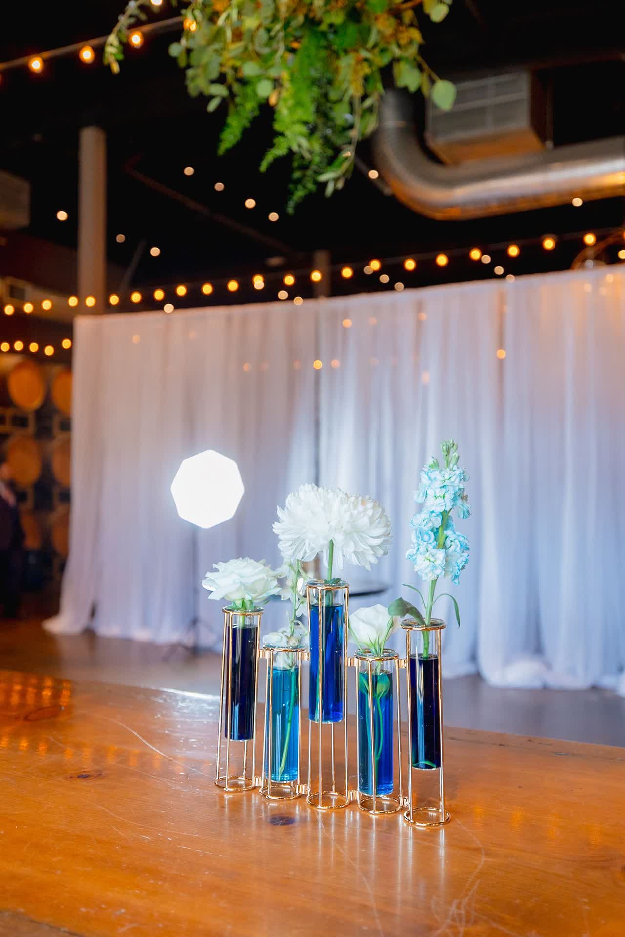 Reception tables and lighting inside a winery event space