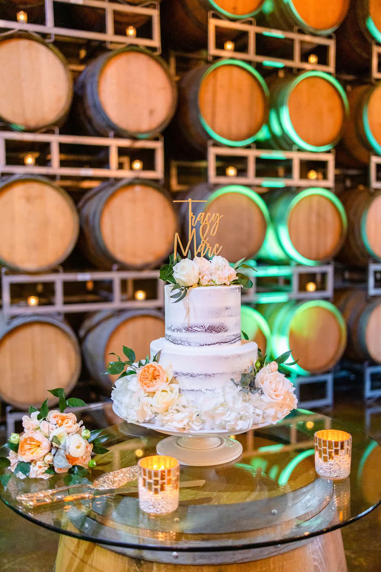 Wedding cake surrounded by soft floral arrangements
